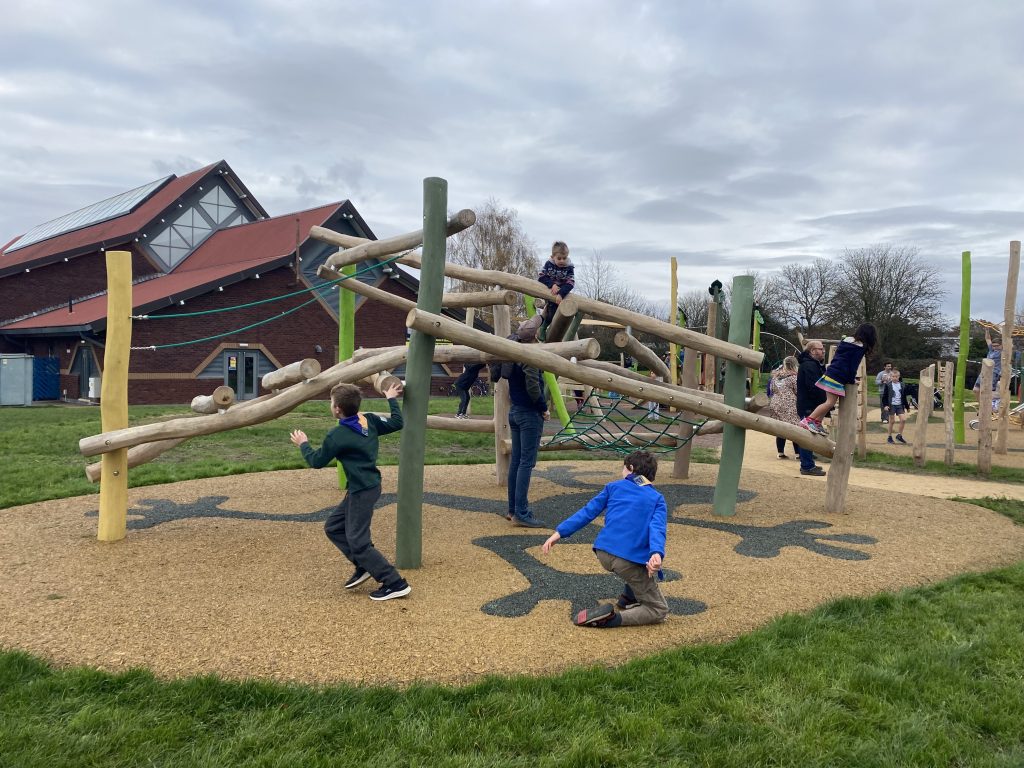 Children playing on play equipment at Penns Playing Fields.
